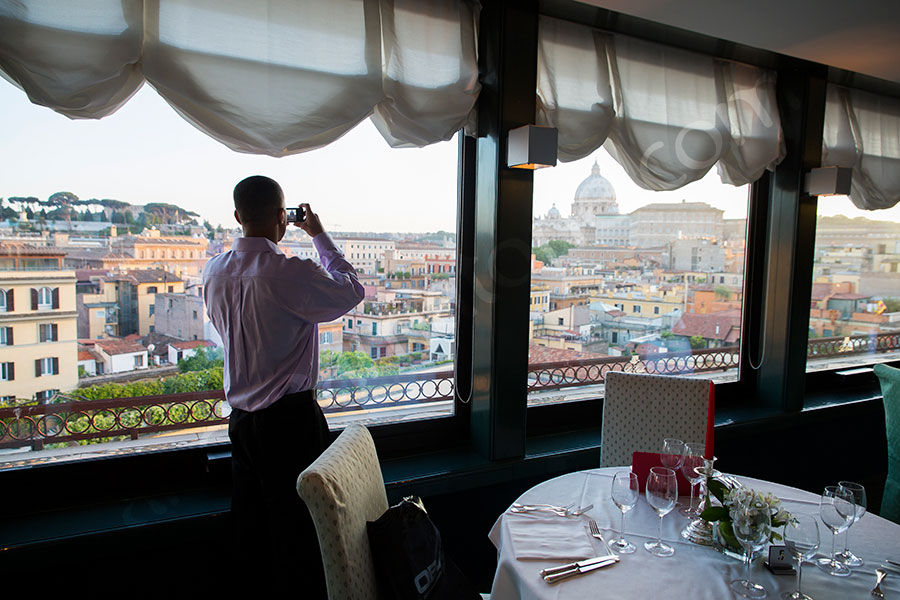 Surprise wedding marriage proposal. Taking a picture of Saint Peter's Dome from a restaurant.