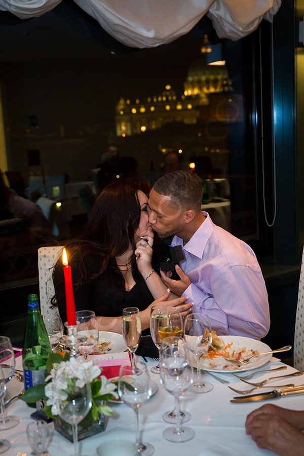 Couple kissing at a restaurant after engaged to be married