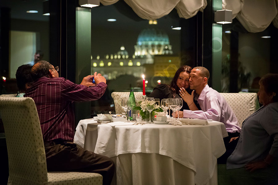 Father photographer taking a picture of the engaged couple