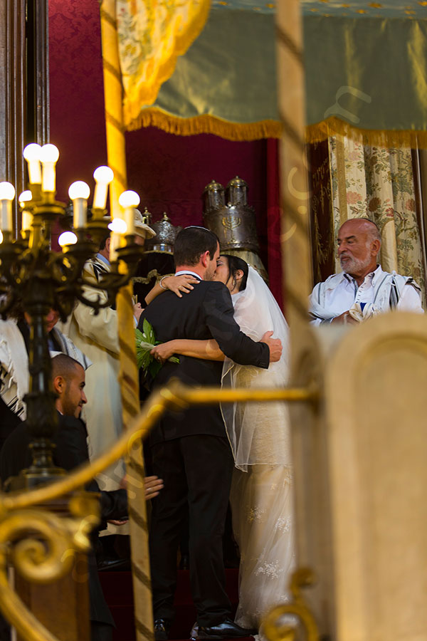 Bride and groom kiss after the matrimony