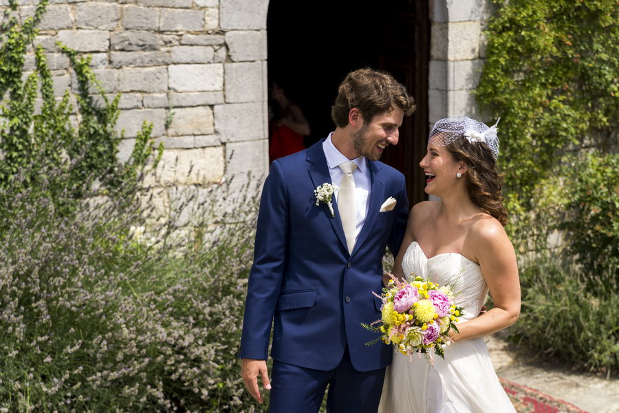 Newlyweds smile at each other just outside Church Castello di Spaltenna.