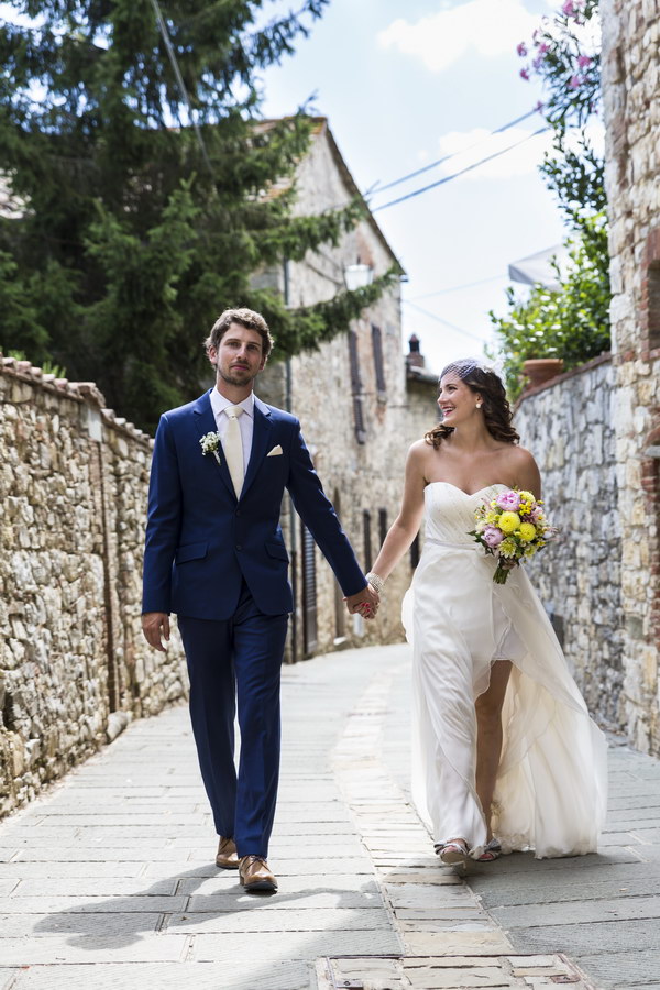 Newlywed couple walking hand in hand