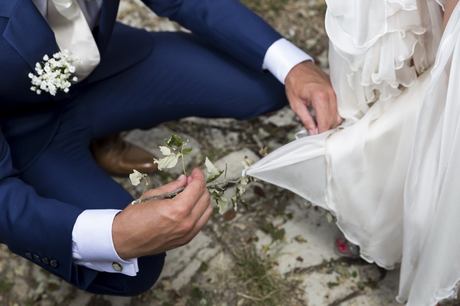 Helping her take off spines caught up on the bridal dress