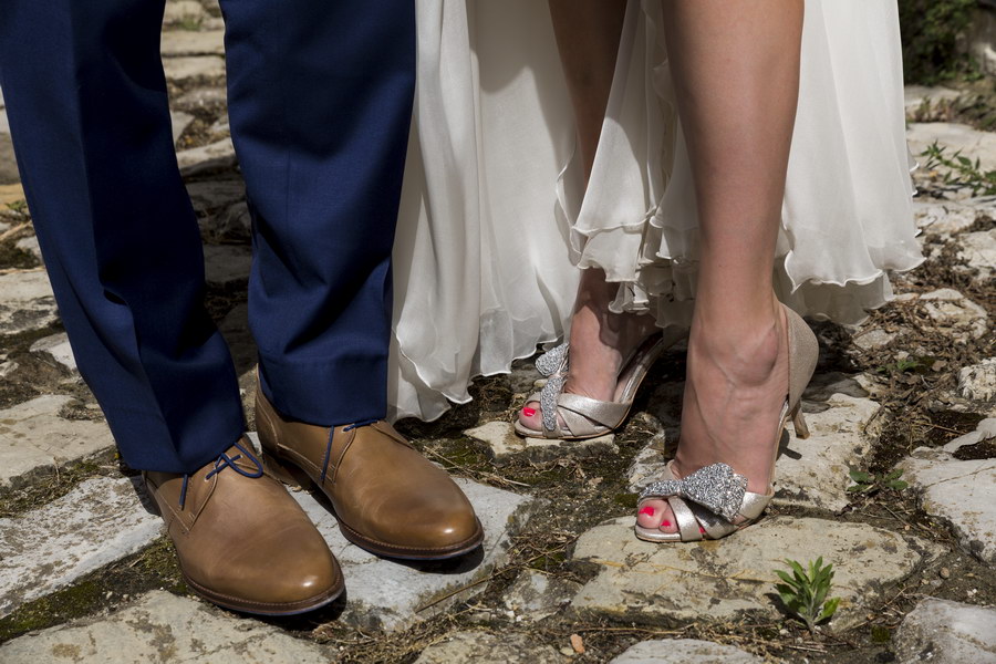 The feet of the newlyweds shoes close up