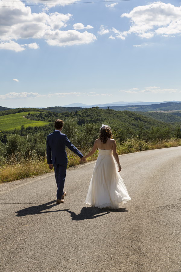 Walking hand in hand on a road in the Chianti region Italy