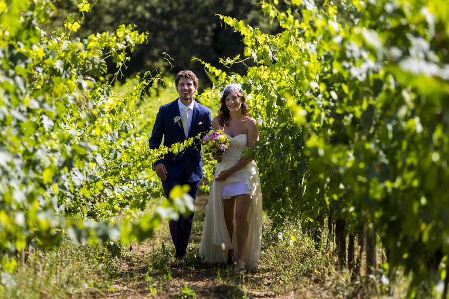 Bride and groom walking in a vineyard in Tuscany Italy Wedding Photographer