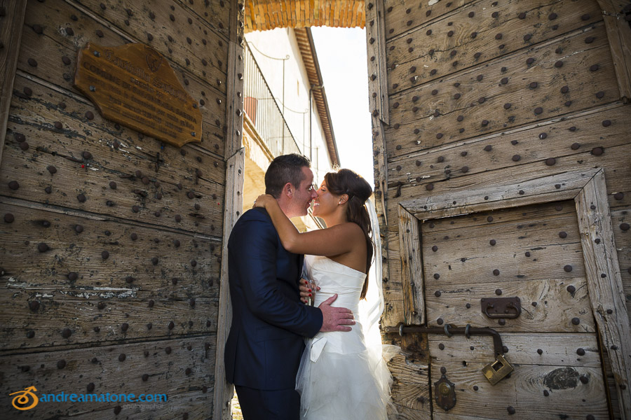 Bride and groom kissing at the doors of Castle Savelli Palombara Sabina Italy