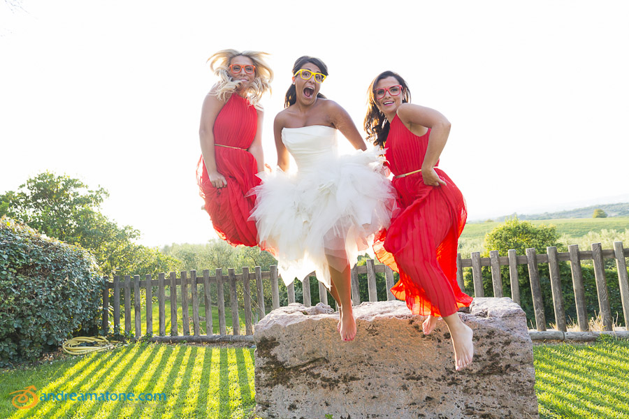 Bride jumping in the air with the bride's maids.