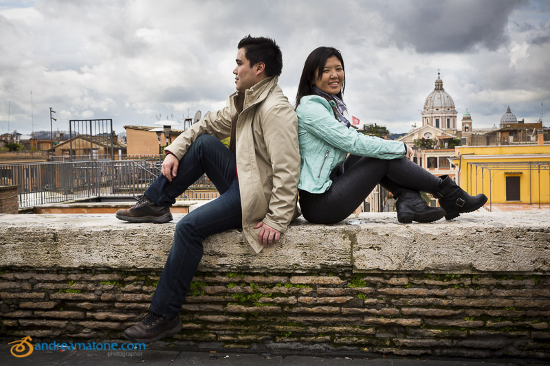 Sitting down on the side wall overlooking the beautiful view of the city