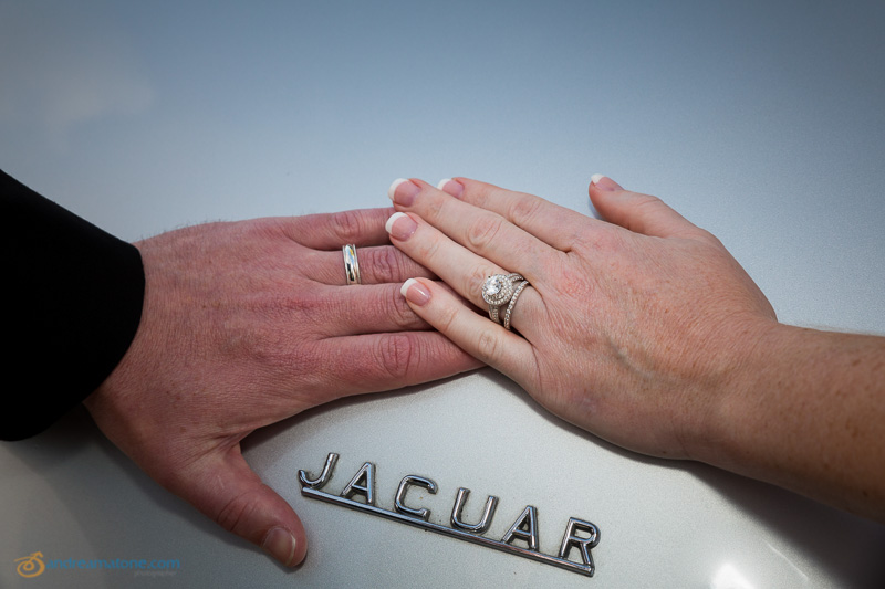 Hands together with rings on the Jaguar vintage car 