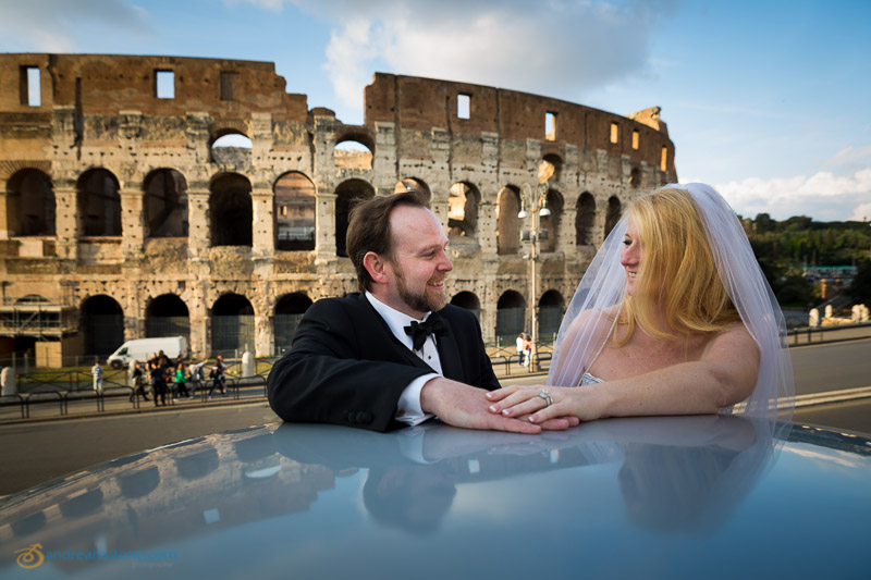 Married couple together in front of the Roman Colosseum.