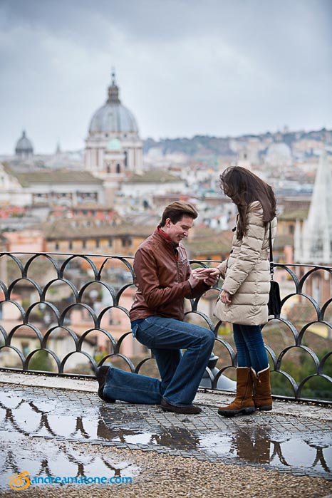 Putting on the engagement ring after asking the most important question. Pincio terrace overview. Proposal Photographer in Rome 