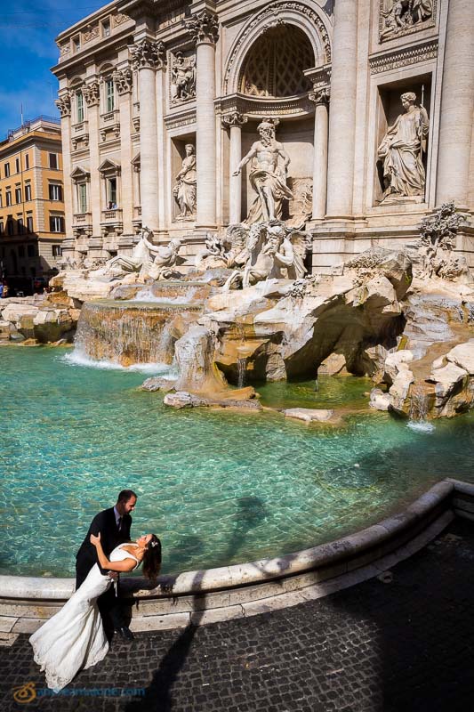 Romantic wedding couple kissing at the Trevi fountain