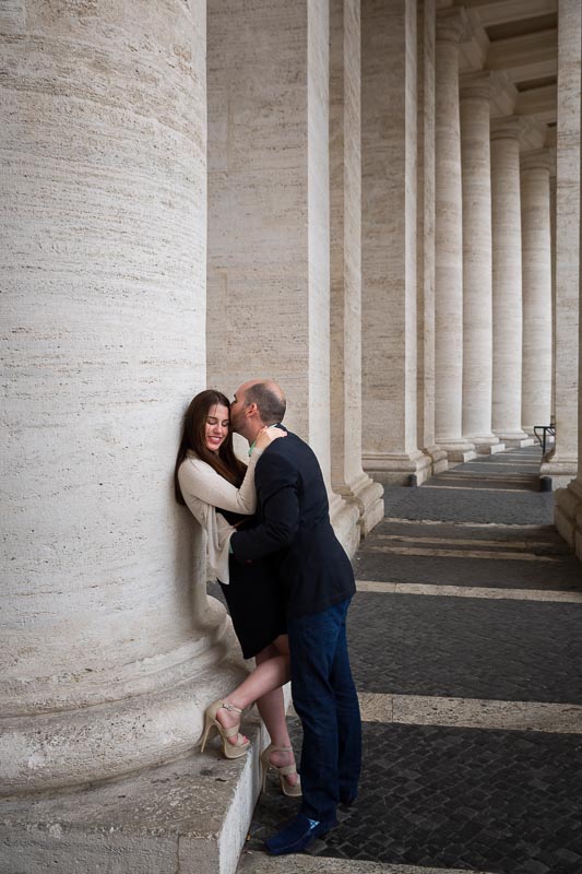 Couple in love under the columns of Saint Peter's square in the Vatican city