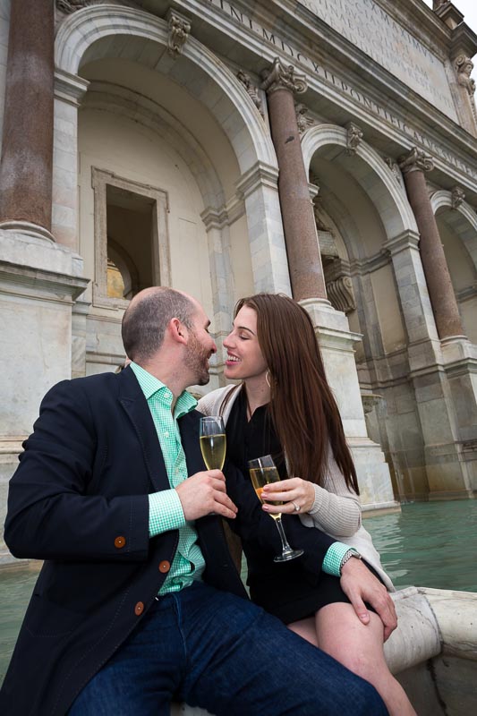 Engaged couple kissing at Gianicolo water fountain