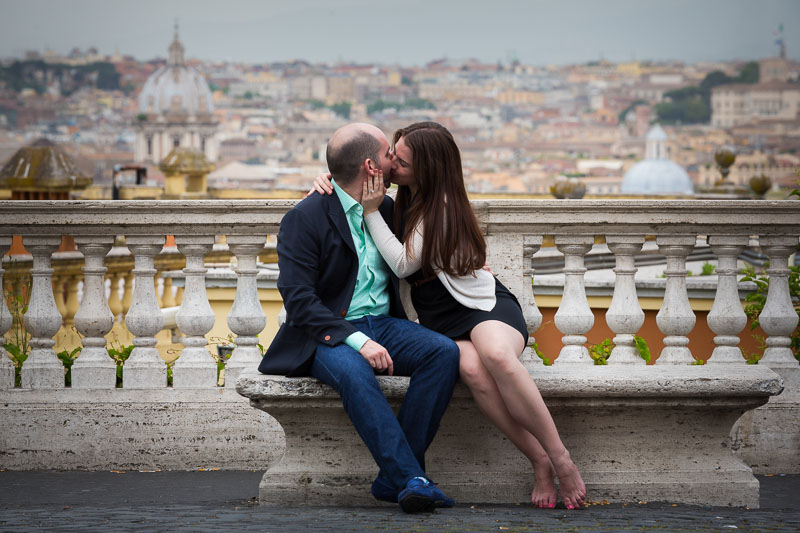 Man and woman together in Rome during an engagement session. View of the roman skyline.