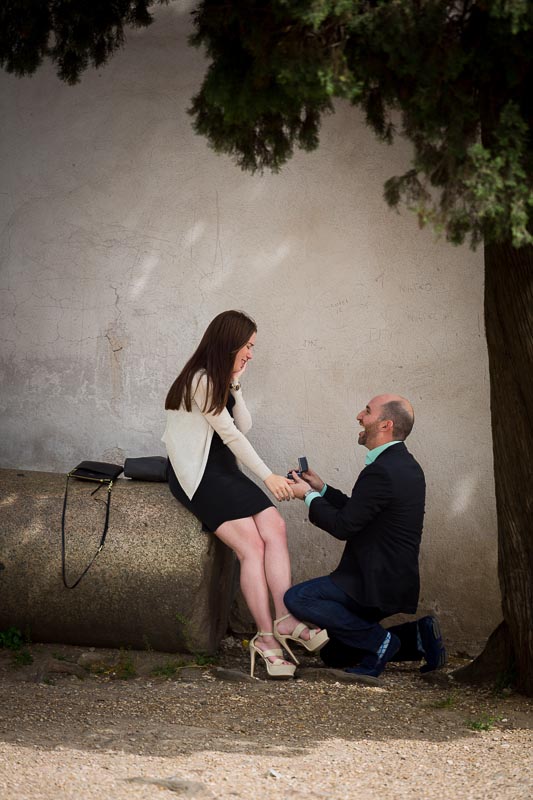 Man on one knee during the surprise proposal Rome Italy.