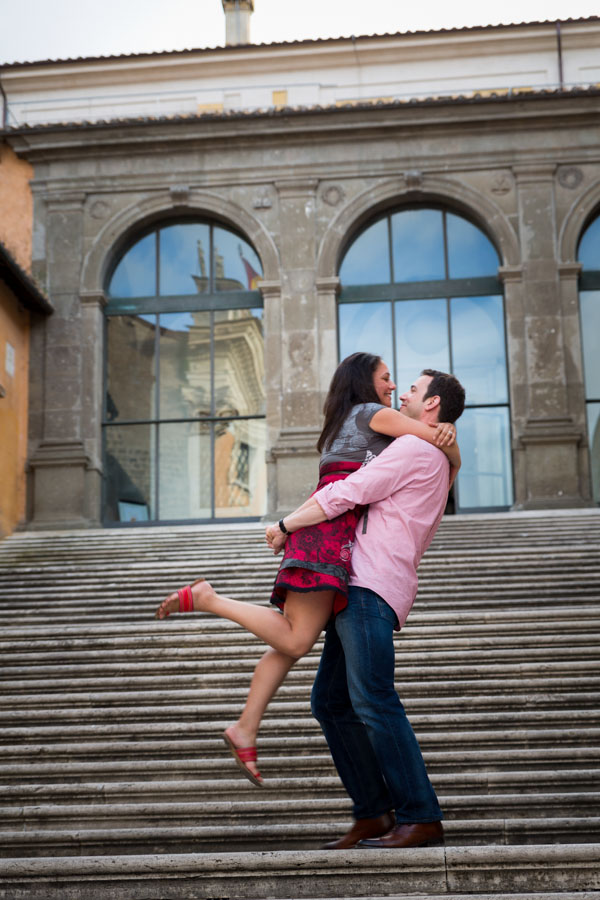 Man picks up woman on the steps of Piazza del Campidoglio.