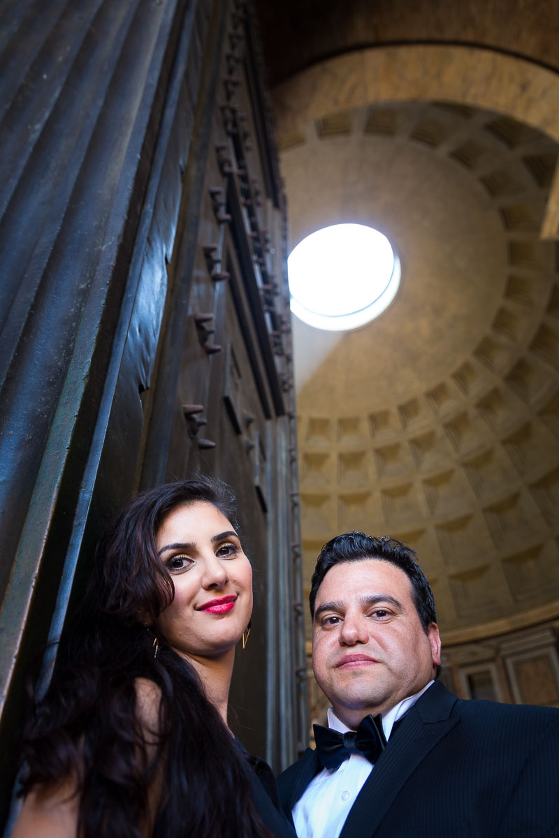 Couple underneath the light shining though the roof of the Pantheon