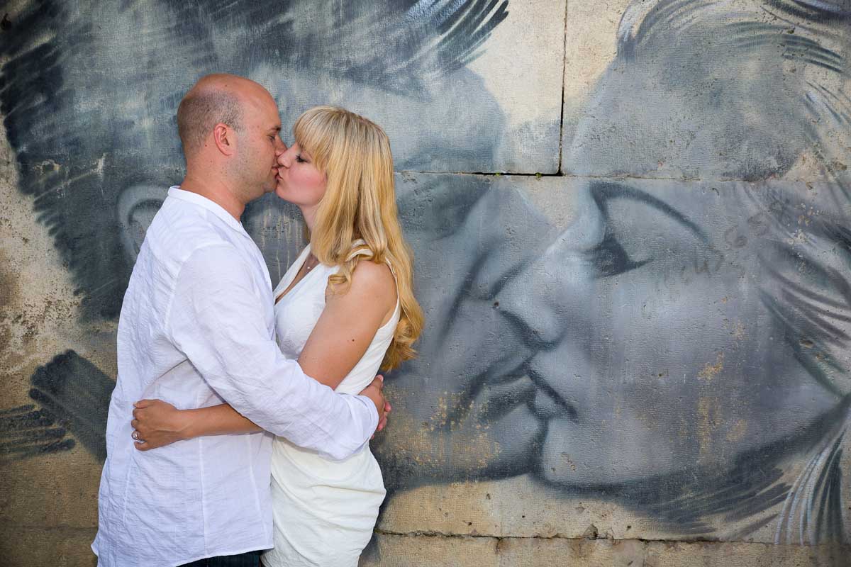 Kissing replicating a graffiti kiss.