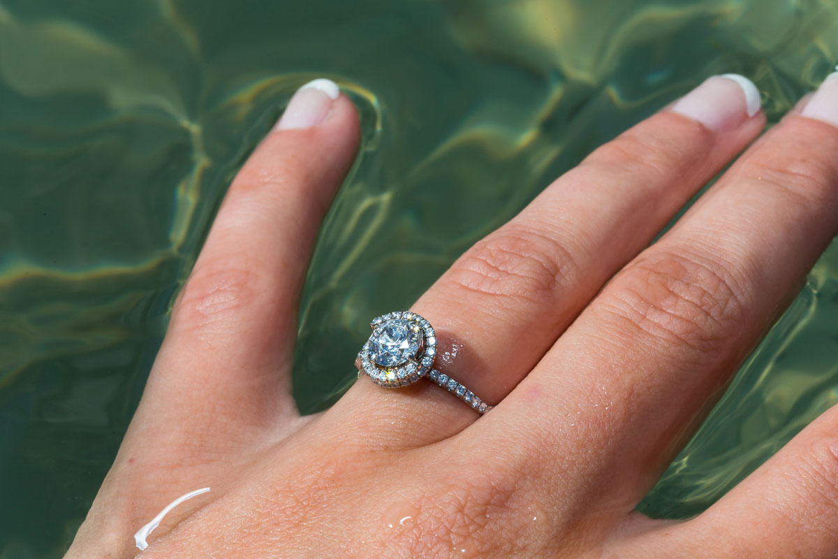 Still life image of the ring immersed in emerald green water.