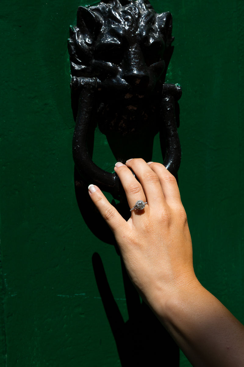 Close up of the engagement ring photographed on a green door.