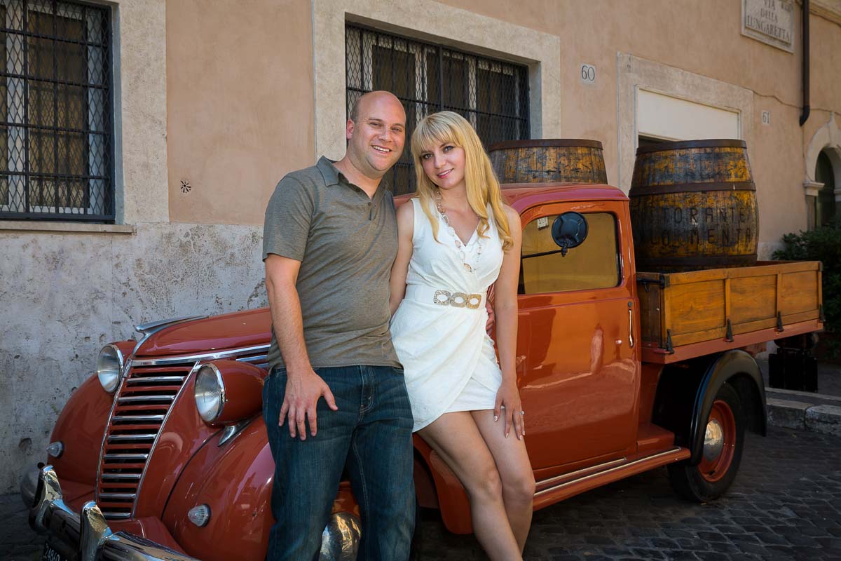 Couple portrait by a vintage truck carrying barrels.