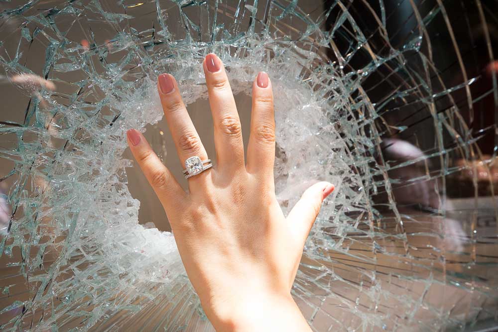 Close up picture of the wedding ring photographed behind broken glass.