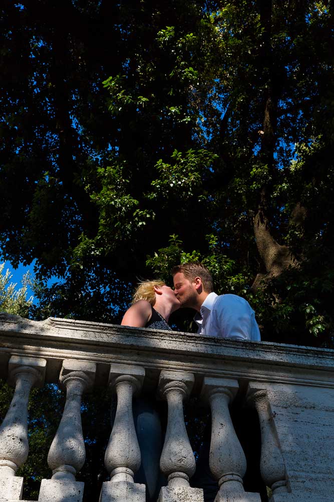 Romantic Marriage Proposals. A kiss underneath a tree in a park.