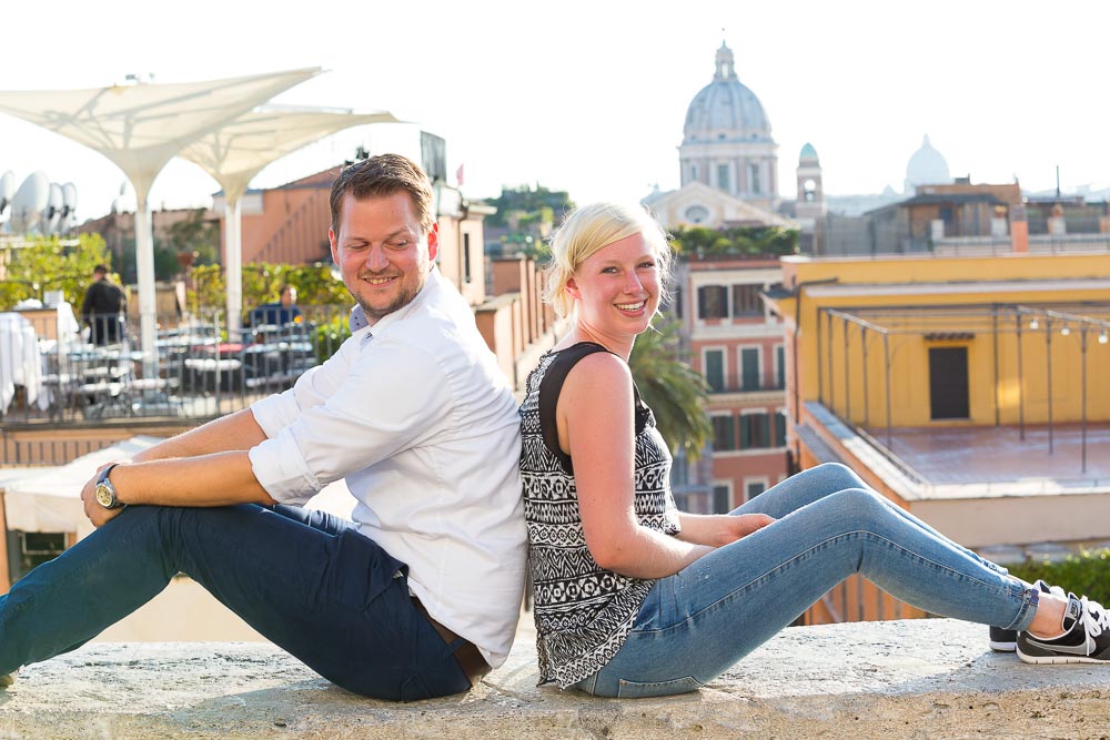 Sitting down on a wall during an engagement session.