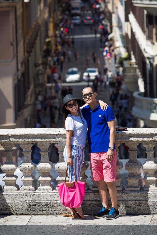 Posed picture of a couple at the Spanish steps overlooking Via Condotti.