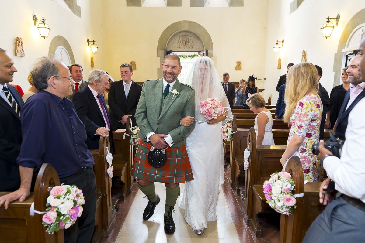 Father taking the bride to the alter to get married.