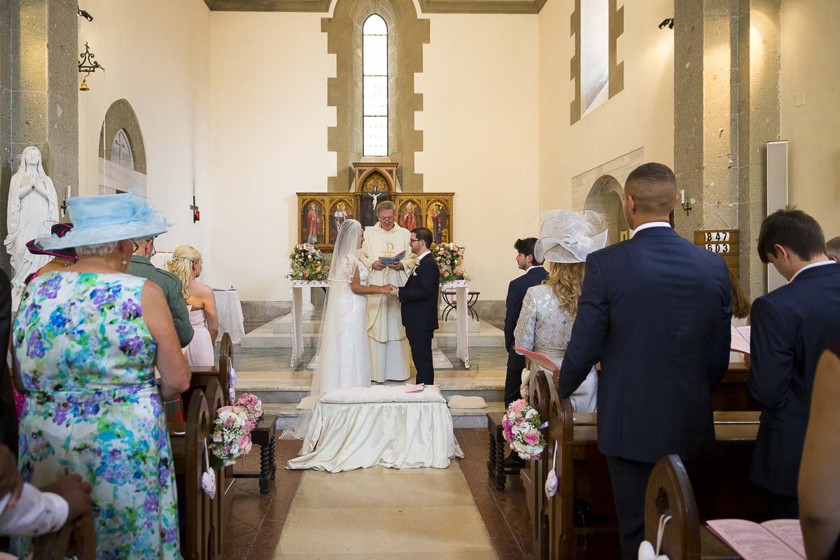 Bride and groom at the alter celebrating marriage.