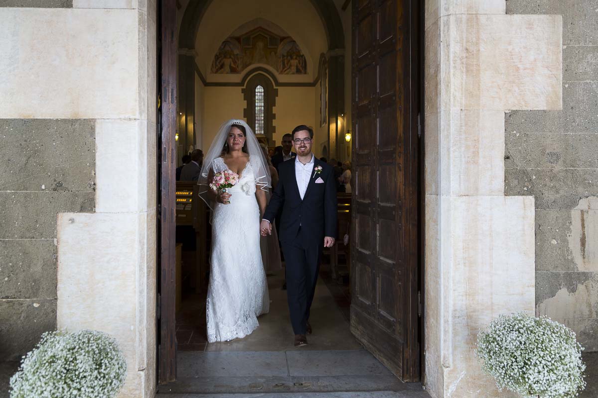 Newlywed exiting Villa Palazzola Church in Italy.