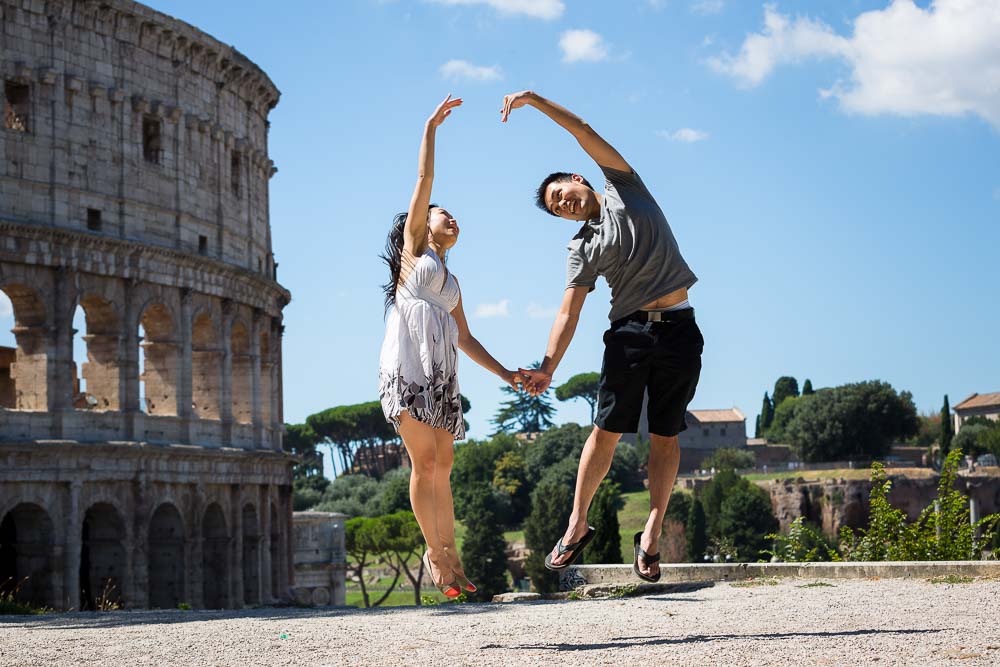 Making a heart shaped by jumping at the Roman Colosseum in Rome.