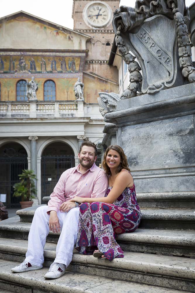 Sitting down on the steps of Piazza Santa Maria in Trastevere with the Church in the background.