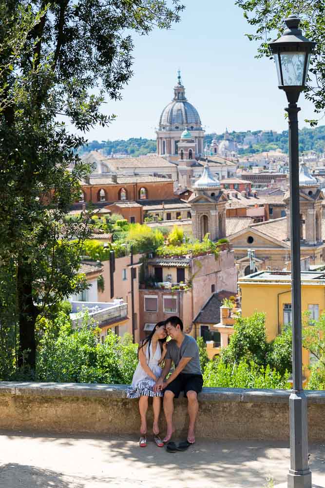 Man and woman together at Parco del Pincio overlooking the roman rooftop view.