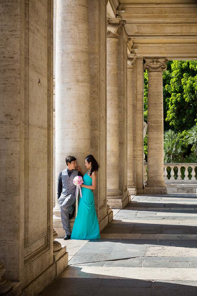 Matrimonial photo shoot underneath columns and portico. Creating lighting effects in between columns.