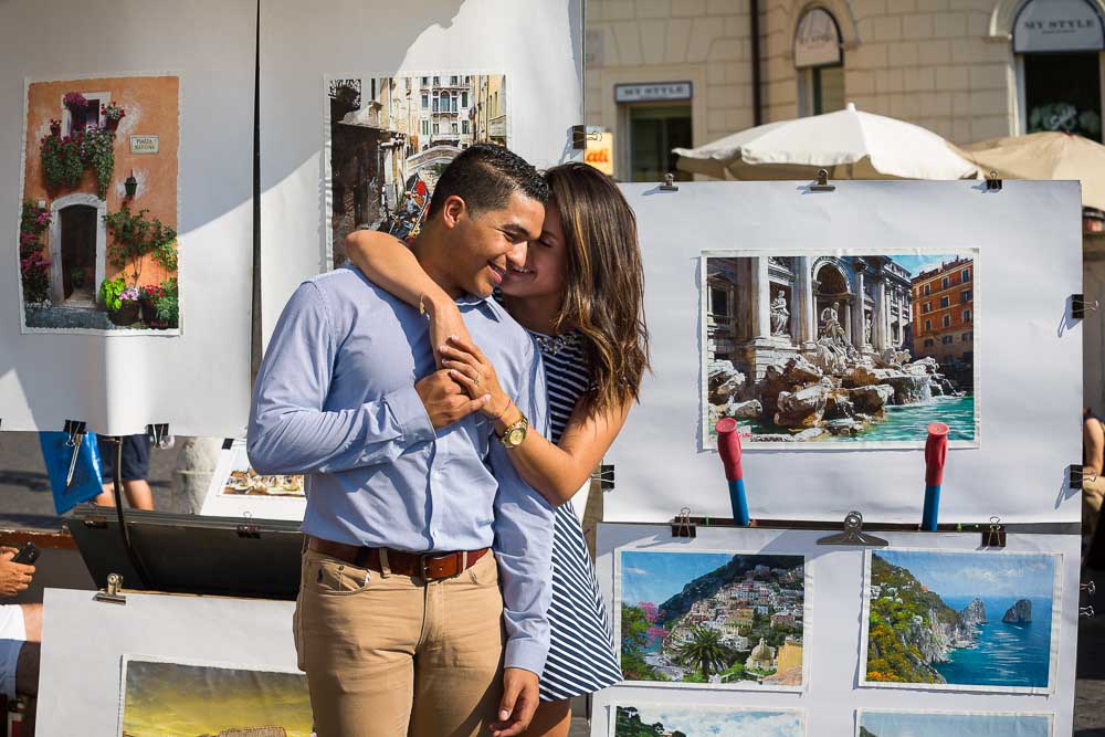 Engaged in Italy. Picture of a couple in front of paintings.