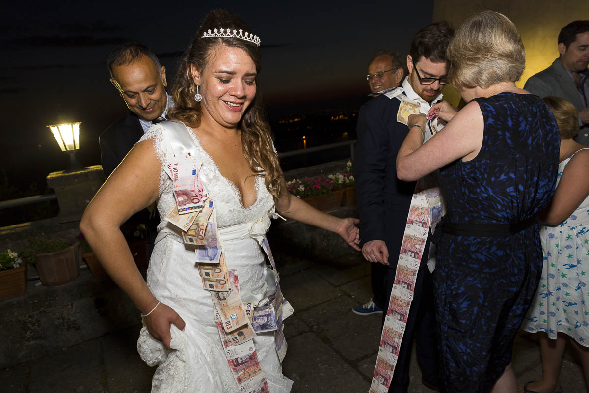 Money dance. Pinning money onto the newlyweds. Greek wedding tradition.