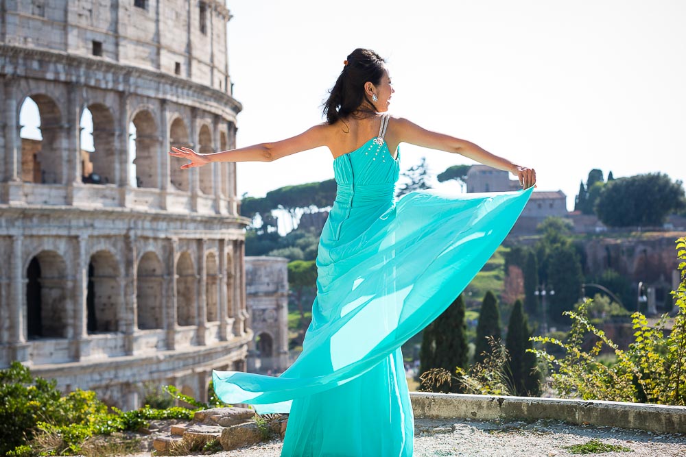 Dress picture of a girl rotating in a circle by the Coliseum.