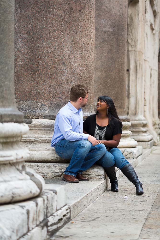 Sitting down at the Pantheon at the base of the large columns.