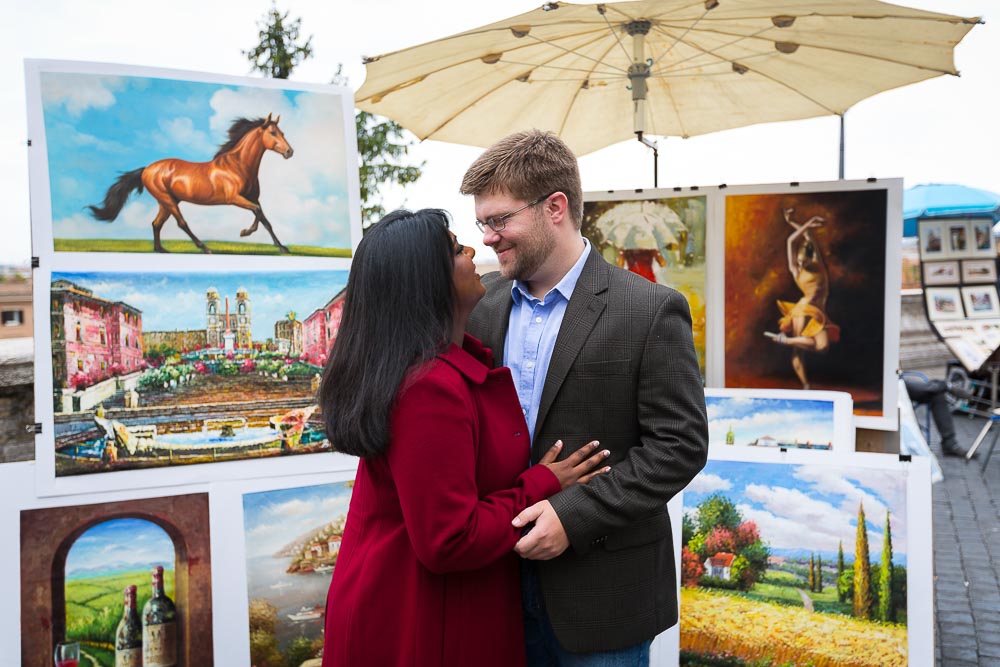 Engagement style picture near the paintings on top of Trinita' dei Monti.