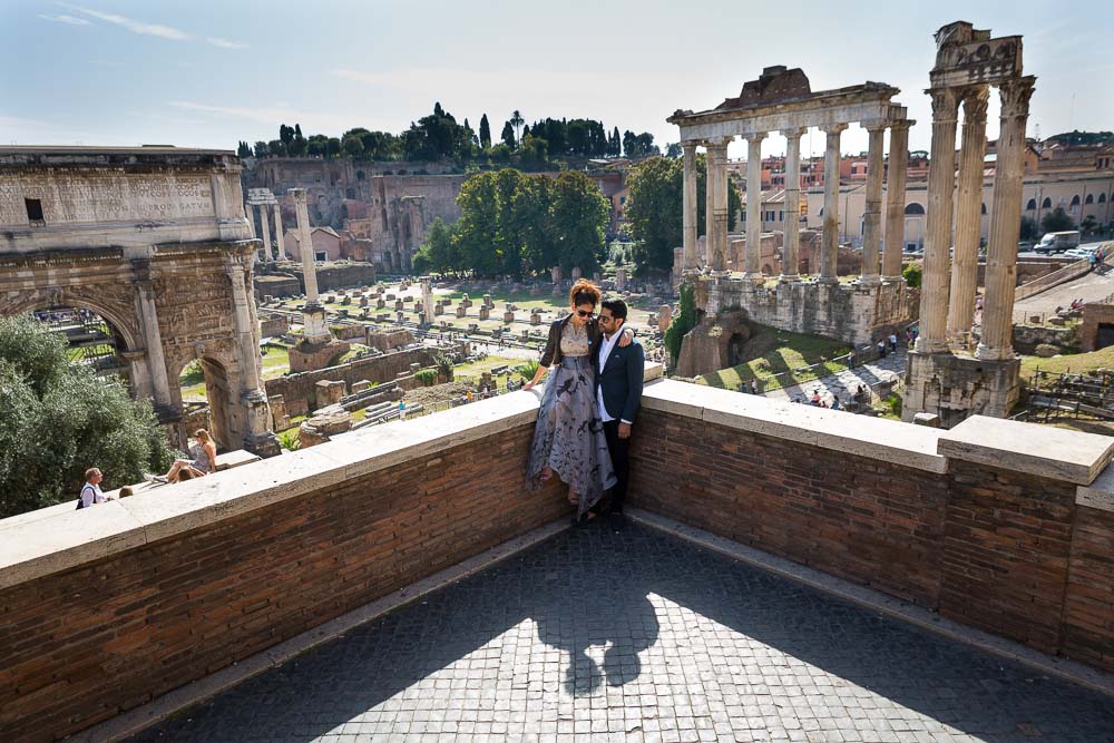 Picture of a man and woman at the ancient Forum with the ruins in the background.