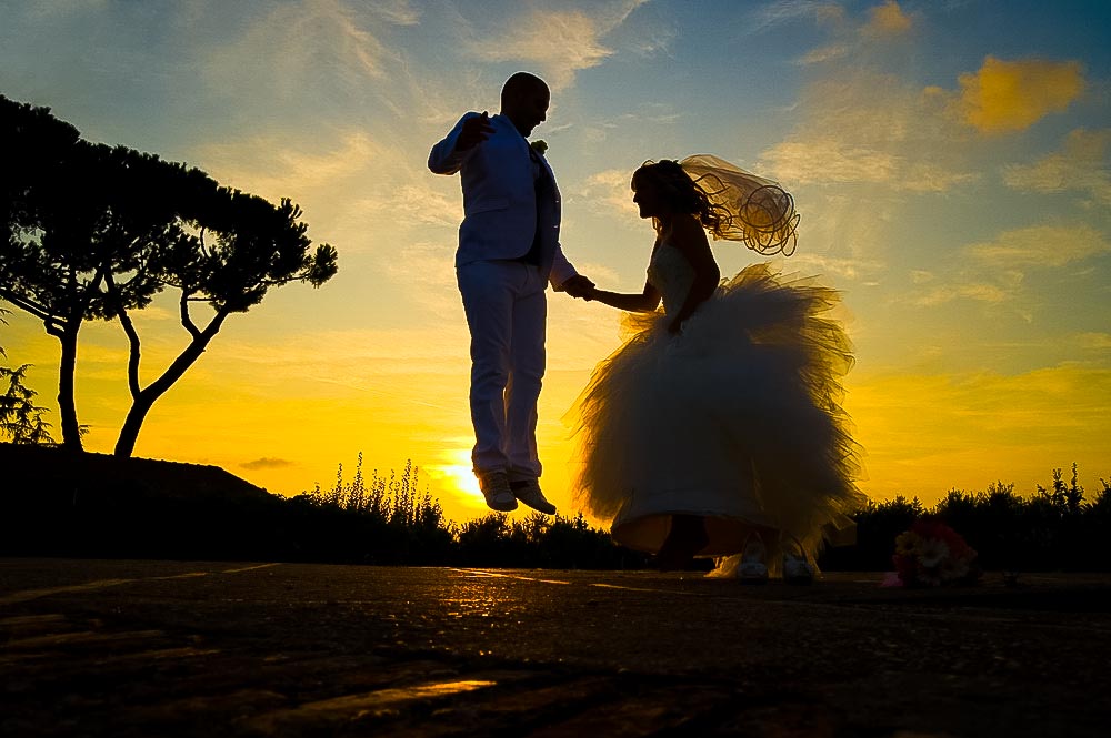 Wedding photography at sunset. Jumping in the air.