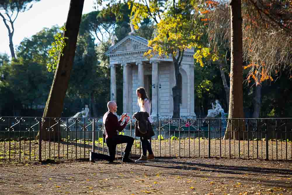 Lake side wedding proposal photographed at the Villa Borghese park in Rome, Italy.