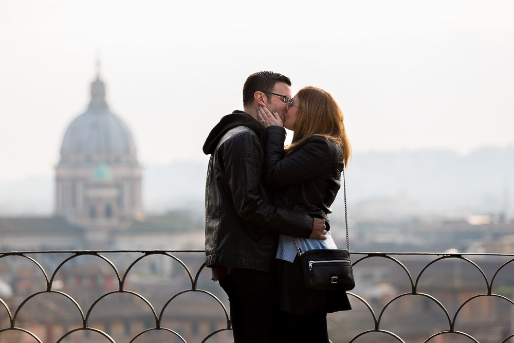Kissing in Rome with the beautiful skyline behind