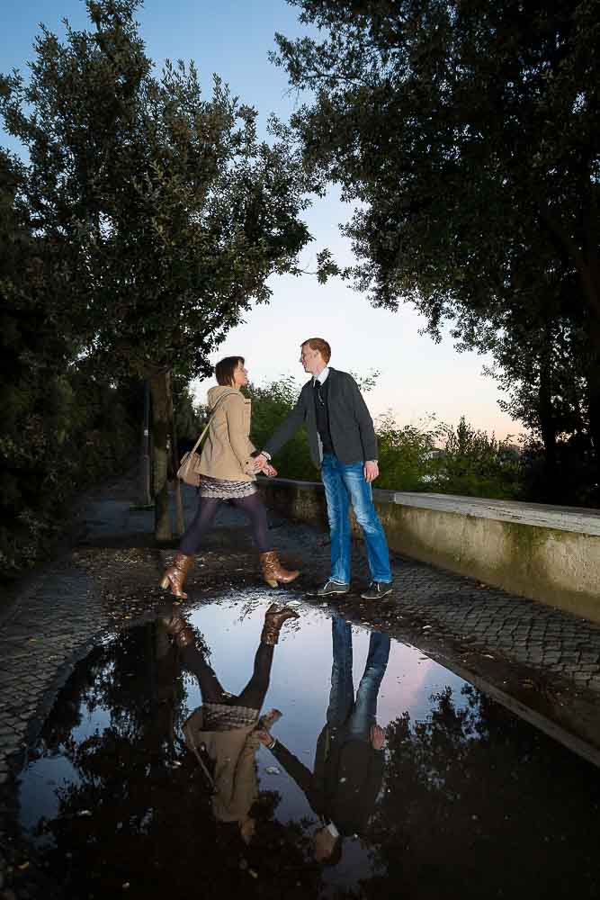 Jumping over puddles during a creative engagement session by Andrea Matone photographer.