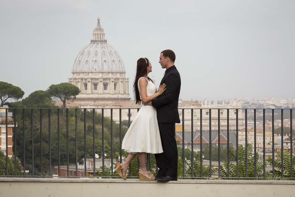 Couple on their honeymoon in Rome overlooking the roman Vatican dome.