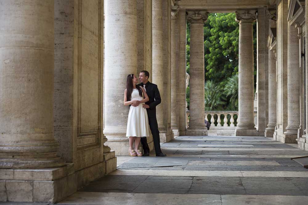 Leaning underneath columns in Piazza del Campidoglio.